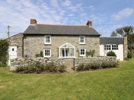 Stone cottage with small garden and lawn in front at Evergreen in Rinsey Cove near Praa Sands