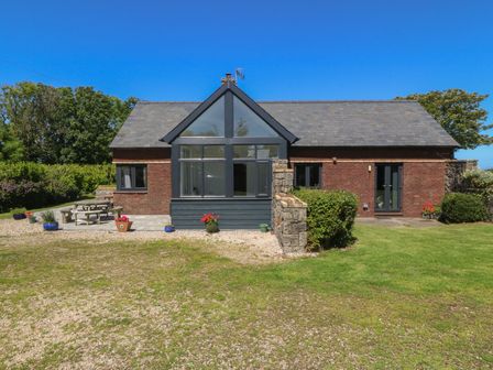 A house with garden furniture and flower pots at Tyn Morfa Llangwnnadl near Aberdaron