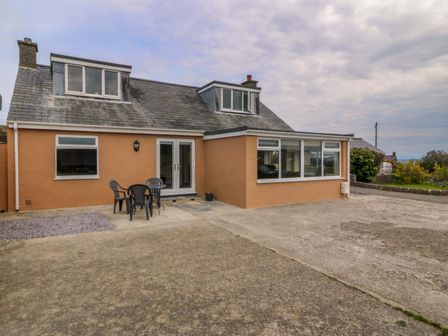 An outdoor view of a house with seating at Dalar Deg in Aberdaron