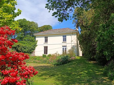 A house with a garden and flowers at The Patio Flat in Bodmin Moor
