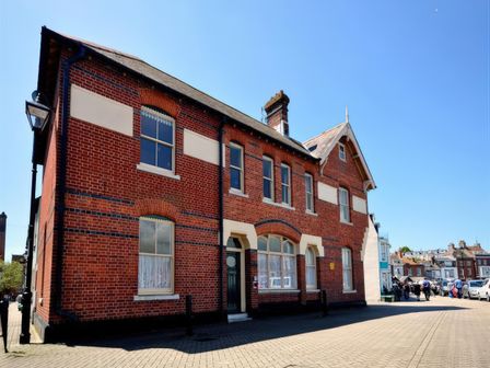An outdoor view of a brick building with windows and a door at Mutiny House, Brewers Quay Harbour