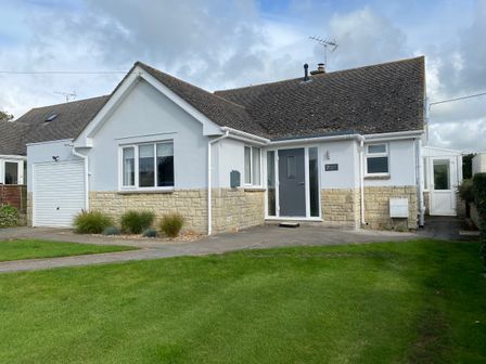 A single-story house with a garage and a lawn at Shipton Hill View in Shipton Gorge
