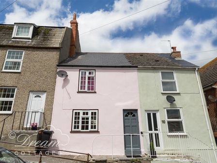 Row of three connected houses with two having painted facades and one with pebble dash exterior