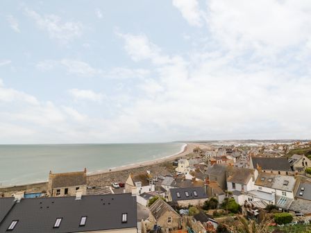 A coastal town with houses along the shoreline and a beach at The View in Portland