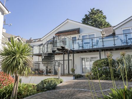 An outdoor view of a building with a staircase and balcony at 19 Bolt Head, Salcombe
