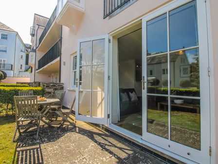 An outdoor space with a table and chairs at 3 Combehaven in Salcombe