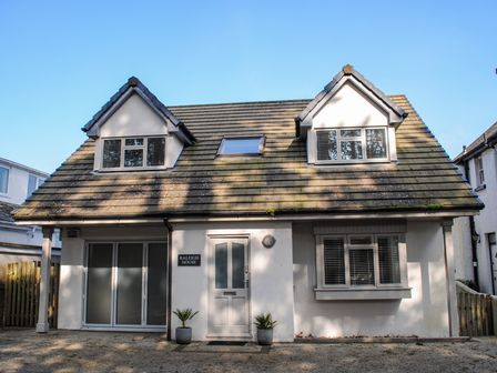 A two-story house with a sloped roof and dormer windows at Raleigh House in Salcombe