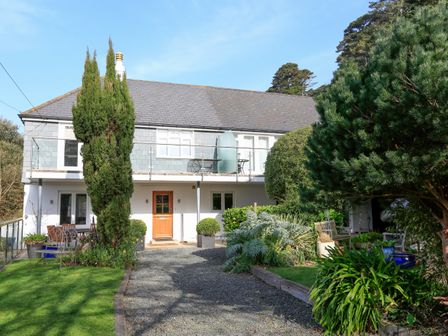 Exterior of a two story house with a gravel driveway and garden at St Elmo Lodge in Salcombe