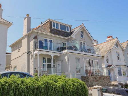 Exterior view of a multi-story house with balconies and glass railings at 1 Lyndhurst Salcombe