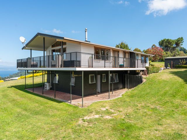 A house with a balcony and satellite dish at Heights Haven - Acacia Bay