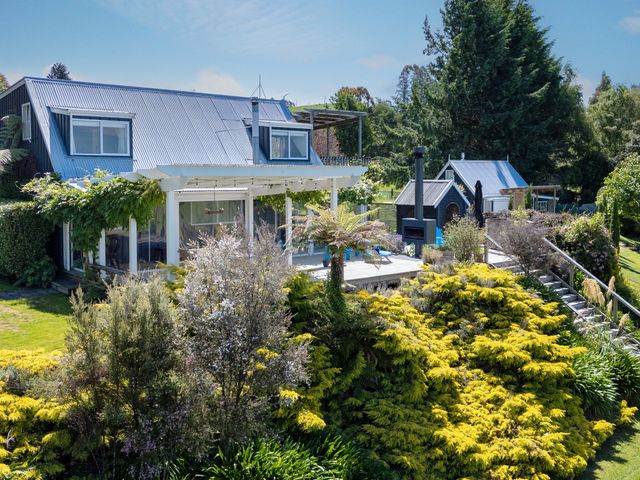A house with a deck and garden at Pukawa Country Lodge - Pukawa Bay