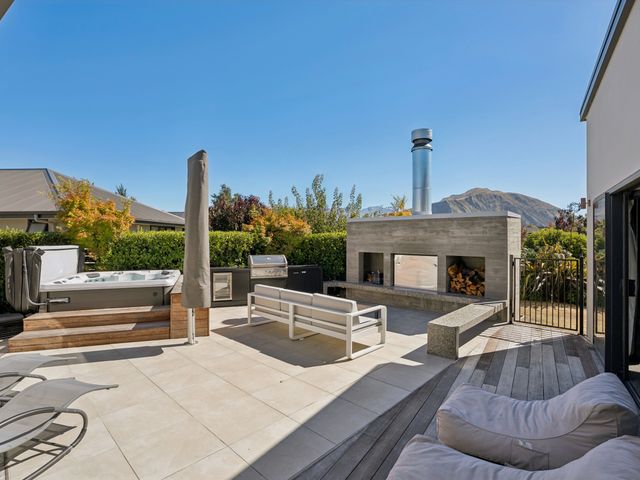 An outdoor area with a hot tub and seating at Casa Central - Wanaka Holiday Home in Wanaka