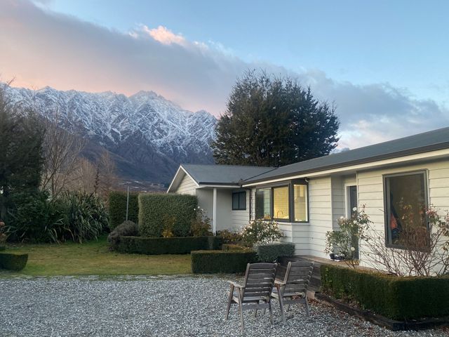 A house with chairs and mountain view at Frankton Favourite - Queenstown Holiday Home, Queenstown