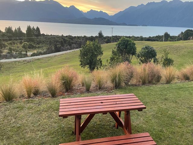 A picnic table with view of the lake and mountains at Southland Sanctuary - Te Anau Holiday Home Fiordland