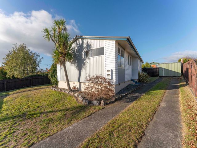 A house with a garden and pathway at The Bay Breeze Retreat - Two Mile Bay