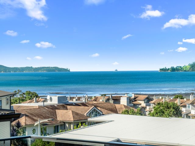 A view of the ocean and rooftops at Kawau Bay Escape - Snells Beach Holiday Home Snells Beach