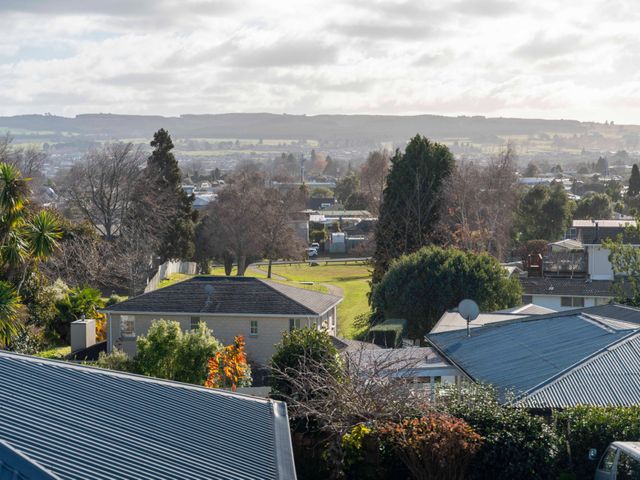 A view of houses and trees with fields in the background at Taupo view road holiday home, Taupo