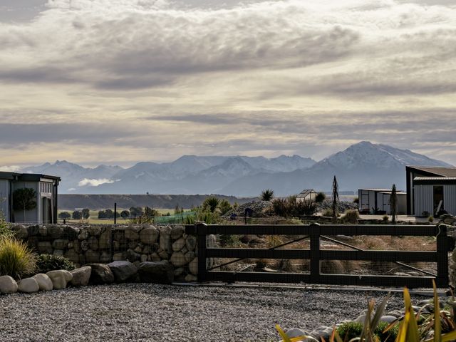 A view of mountains and buildings at Eight on Jackson - Luggate Holiday Home
