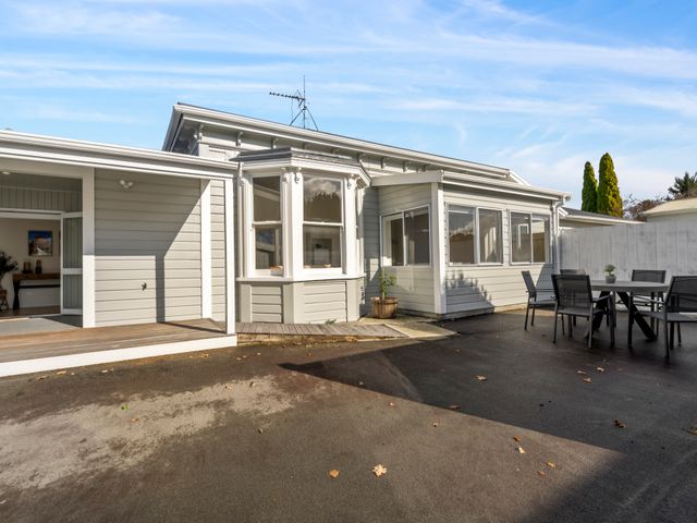 A house exterior with patio area and outdoor furniture at Arbor Villa - Greytown Holiday Home Greytown