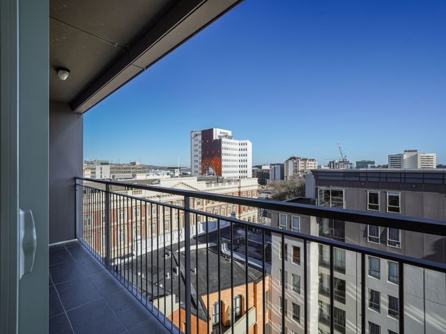 A balcony view of city buildings and clear sky at Downtown Haven - Christchurch Holiday Apartment in Christchurch