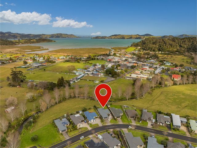 An aerial view of houses and landscape at Coromandel Holiday Home in Coromandel