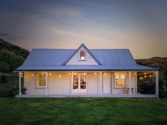 A house with a front porch and outdoor lights at Akaroa Holiday Home