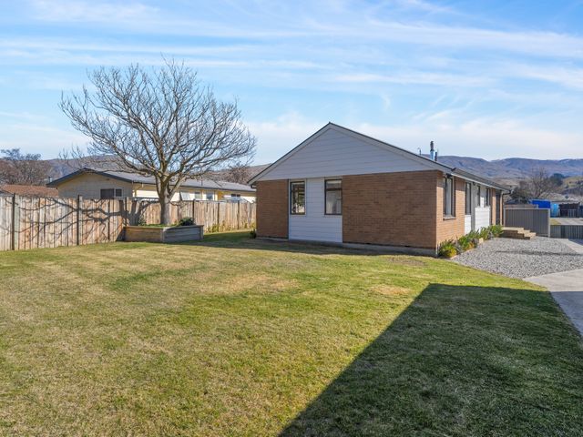 An outdoor view of a house and grassy area at Antimony Retreat - Cromwell