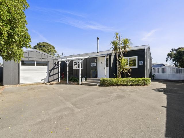 A house with a garage and pathway in front at the property in location