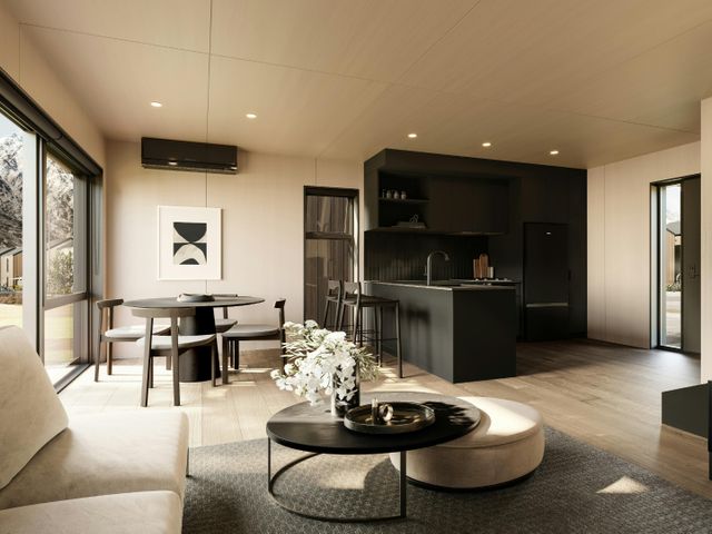 A living room with a dining table and kitchen appliances at Pinnacle Peaks - Queenstown Holiday Home in Queenstown