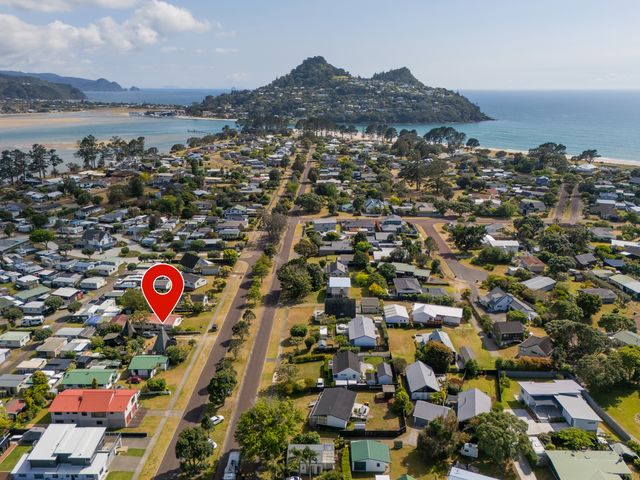 An aerial view of a residential area near the beach featuring houses and roads