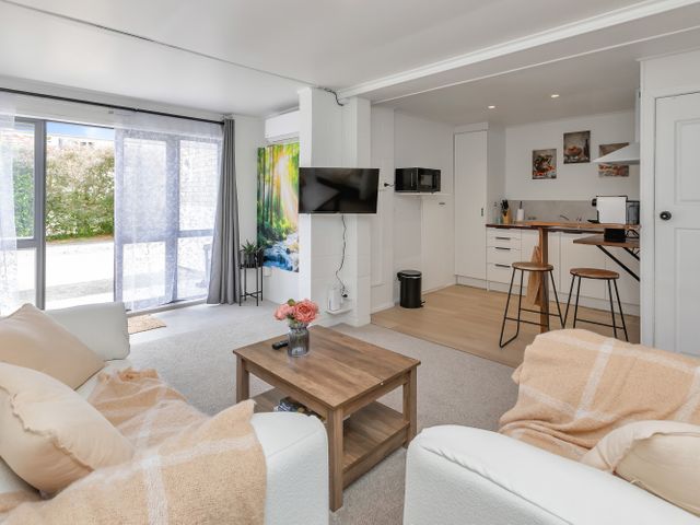 A living room with a coffee table and television at Whangarei