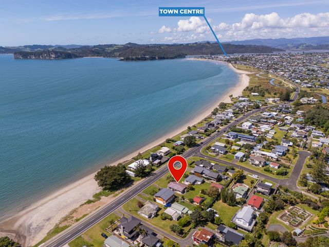 An aerial view of a coastal area with houses and beach near the town centre at Whitianga Holiday Home in Whitianga
