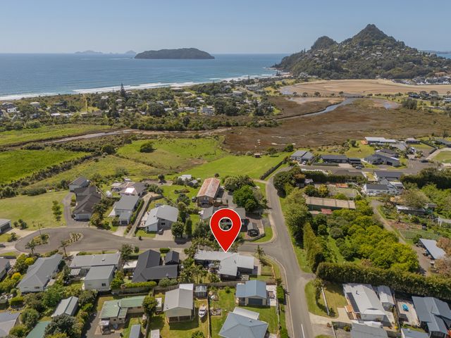 An aerial view of houses near the beach at Tairua Holiday Home in Tairua