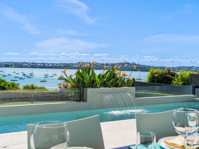 An outdoor area with a pool and flowering plants at Auckland Holiday Home in Auckland