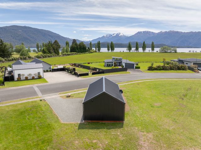 An outdoor view of houses and surrounding landscape at Te Anau Holiday Home Te Anau