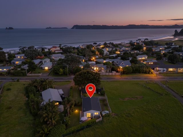 A view of houses near the ocean at Cozy Cottage - Whitianga Holiday Home, Whitianga