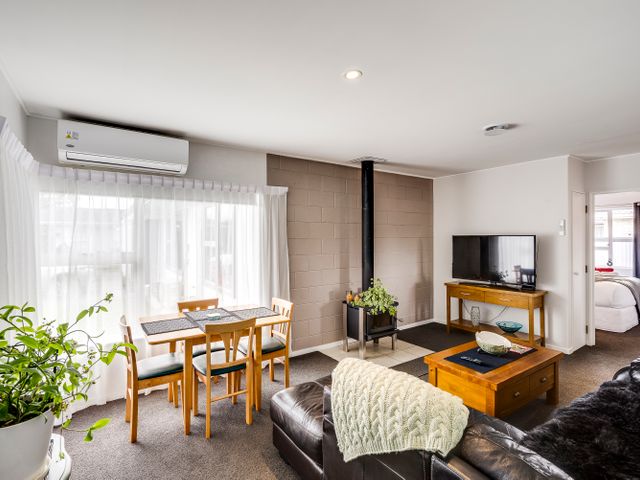 A living room with a dining table and sofa at Cozy on Clive - Hastings Holiday Home