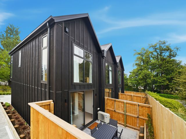 A house with a patio and fence at Hanmer Alpine Chalet - Hanmer Holiday Home Hanmer Springs