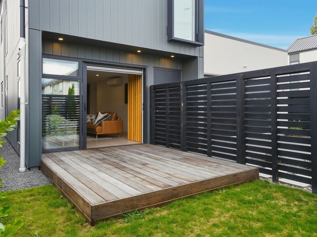 An outdoor area with wooden decking and a fence at Bliss at Madras - Christchurch Holiday Home