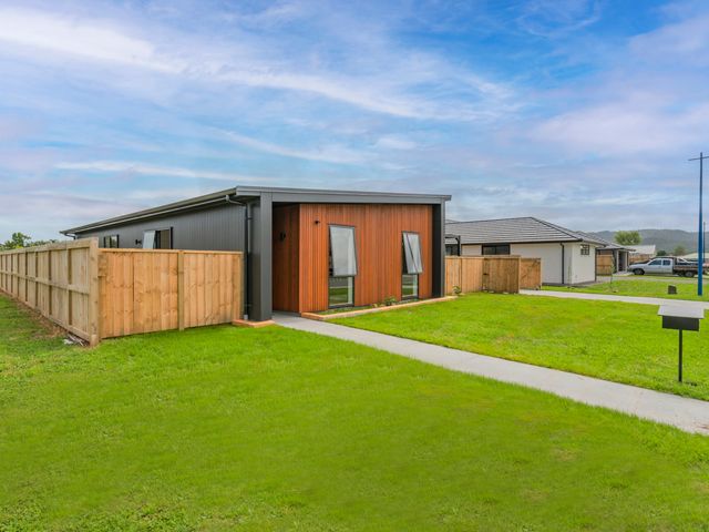 A house with a pathway and fence at Sun and Sea Sanctuary - Whitianga