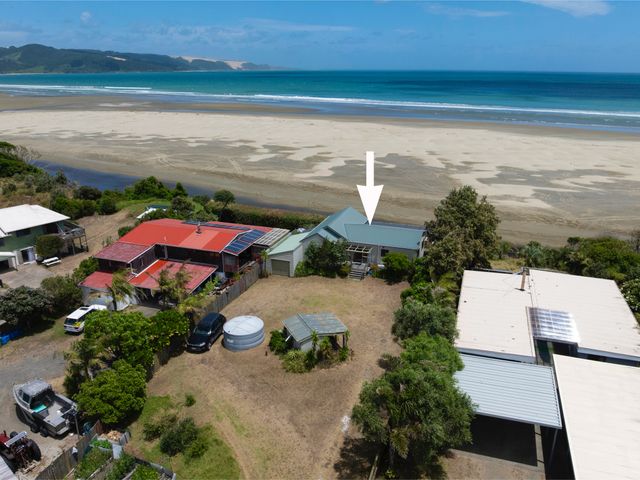 An outdoor view of a house by the beach at Tides and Time Bach - Ahipara Holiday Home Kaitaia