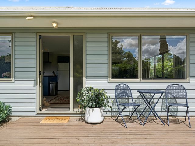 A door with a table and chairs outside at Martinborough Holiday Home Martinborough
