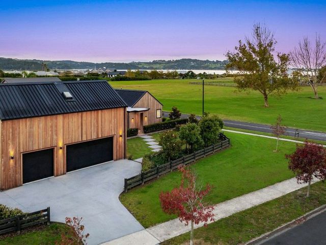 A house with a garage and driveway at The Coastal Studio - Point Wells Holiday Home Point Wells