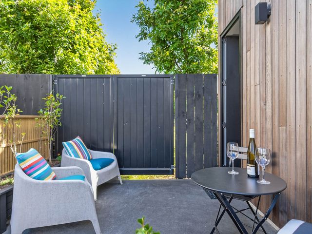 An outdoor patio with chairs and a table at The Coastal Studio - Point Wells Holiday Home in Point Wells
