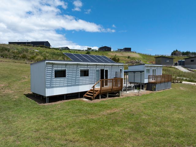 A house with solar panels and a deck at Coopers Beach