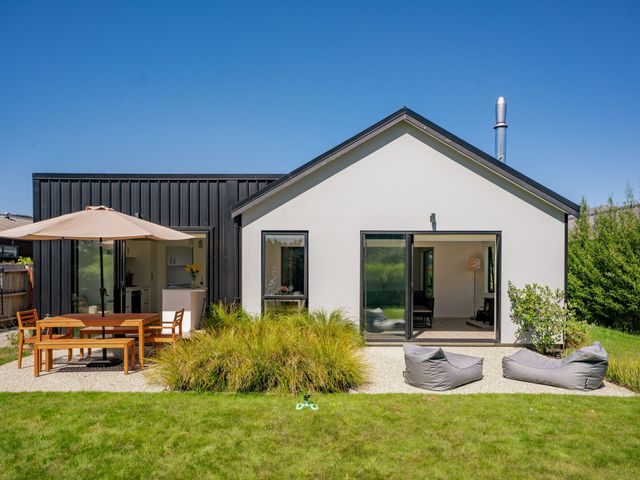 A house with outdoor seating area at Northlake Hideaway - Wanaka Holiday Home Wanaka