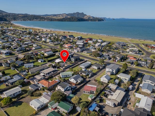 An aerial view of houses near the beach at The Schieck Shack - Whitianga