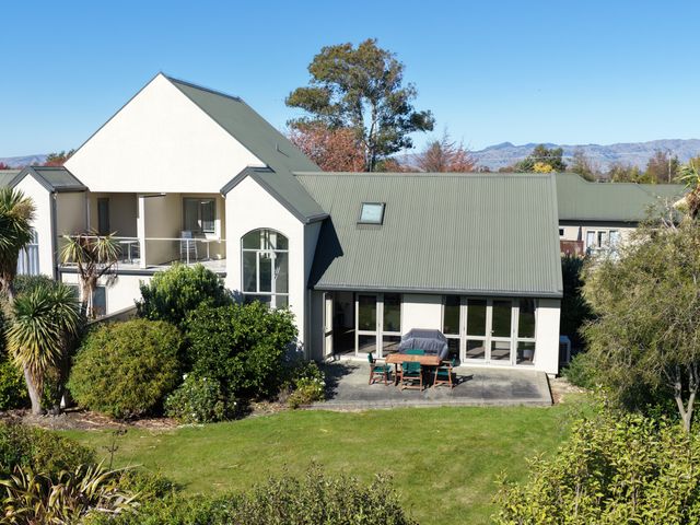 An outdoor dining area with a table and chairs at Vineyard View - Blenheim Holiday Home in Blenheim