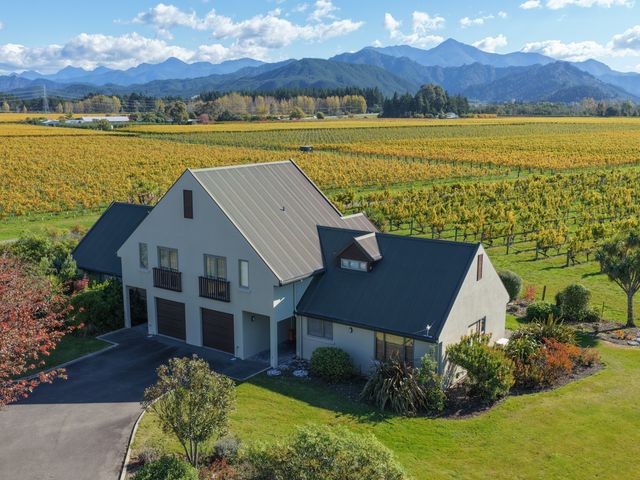 A house with a vineyard backdrop at Vineyard View - Blenheim Holiday Home in Blenheim