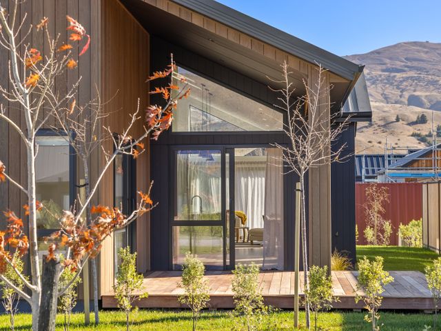 A house exterior with trees and a porch at Cromwell Holiday Home in Cromwell